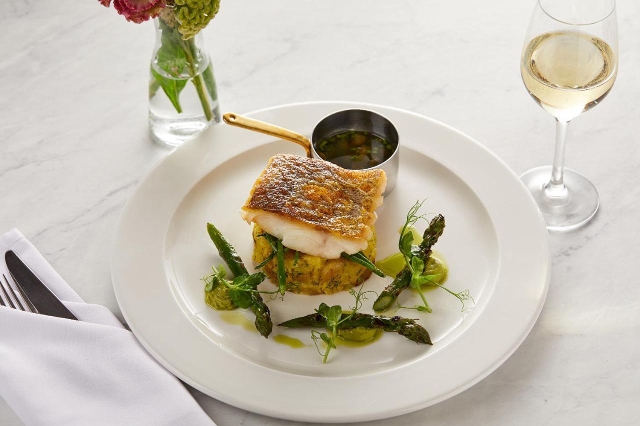 Macdonald Bath Spa Hotel Екстериор снимка The photo showcases a beautifully plated dish featuring a piece of fish, likely with a crispy skin, resting on a bed of what appears to be a savory cake or puree. Surrounding the fish are fresh asparagus and garnishes, adding a touch of color and fre