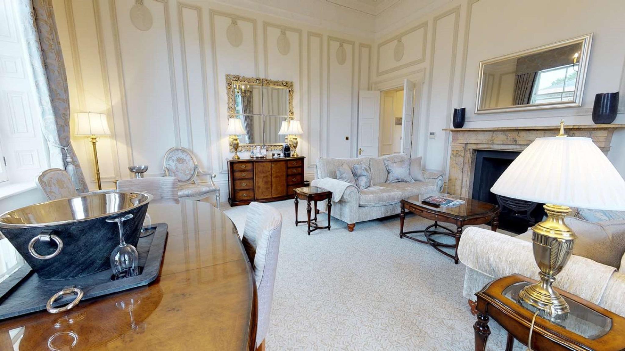 Macdonald Bath Spa Hotel Екстериор снимка The photo depicts a elegantly furnished living room. It features light-colored walls with subtle decorative details and a plush carpet. In the room, there are several pieces of furniture, including a pair of sofas and armchairs arranged around a smal