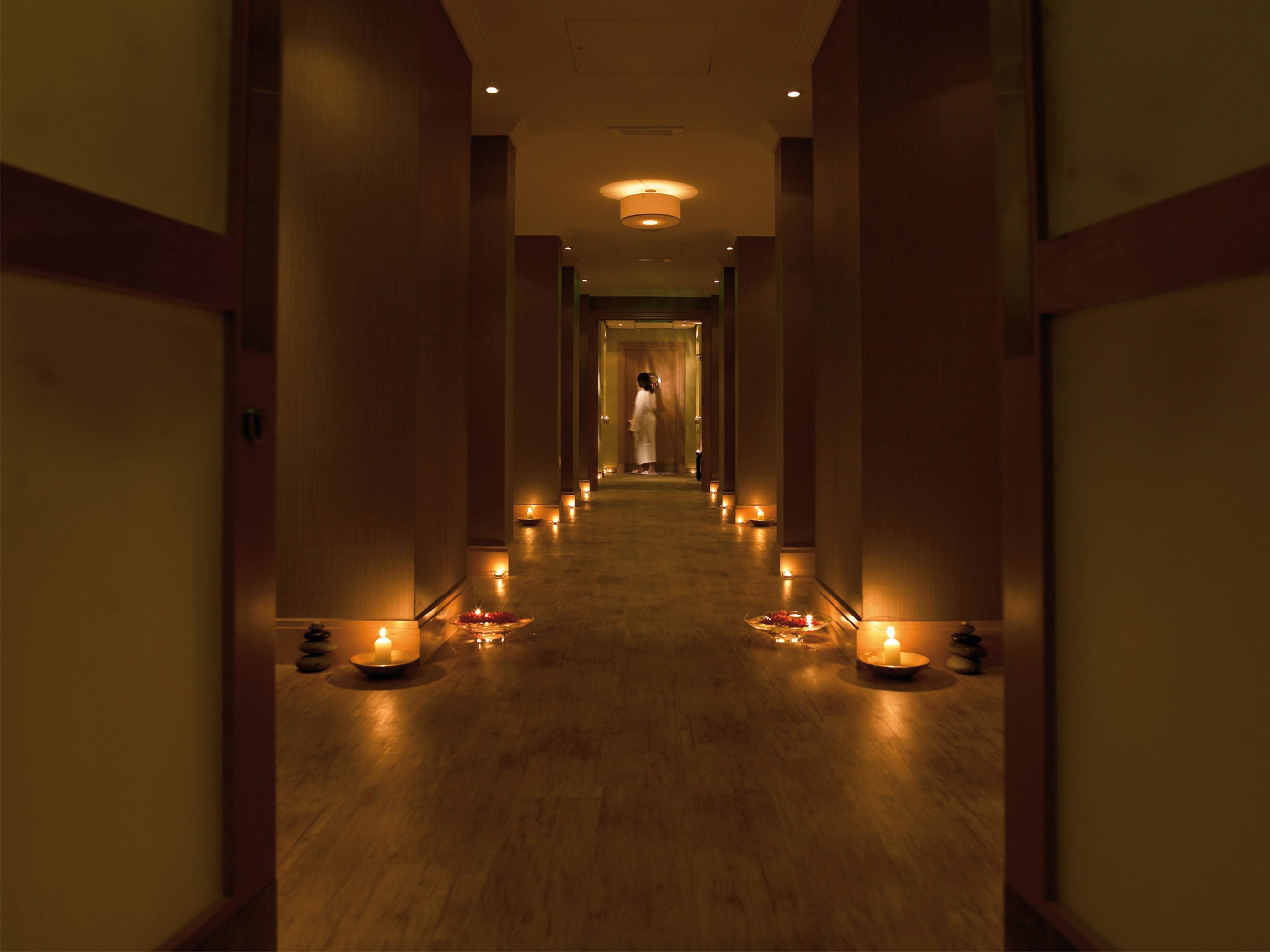 Macdonald Bath Spa Hotel Екстериор снимка The photo shows a dimly lit corridor lined with soft lighting. On both sides of the hallway, small candles are placed in bowls, creating a warm and inviting ambiance. At the end of the corridor, there appears to be a person standing, possibly prepari