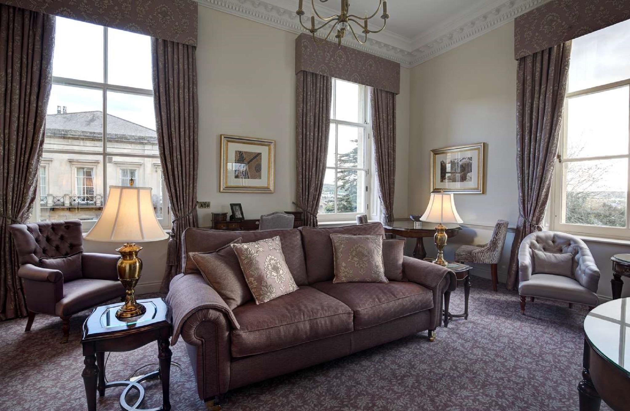Macdonald Bath Spa Hotel Екстериор снимка The photo shows a well-furnished living room with an elegant and cozy atmosphere. There is a brown couch with decorative pillows in the center. Two armchairs are positioned next to it, with a small table in the middle. The room features large windows