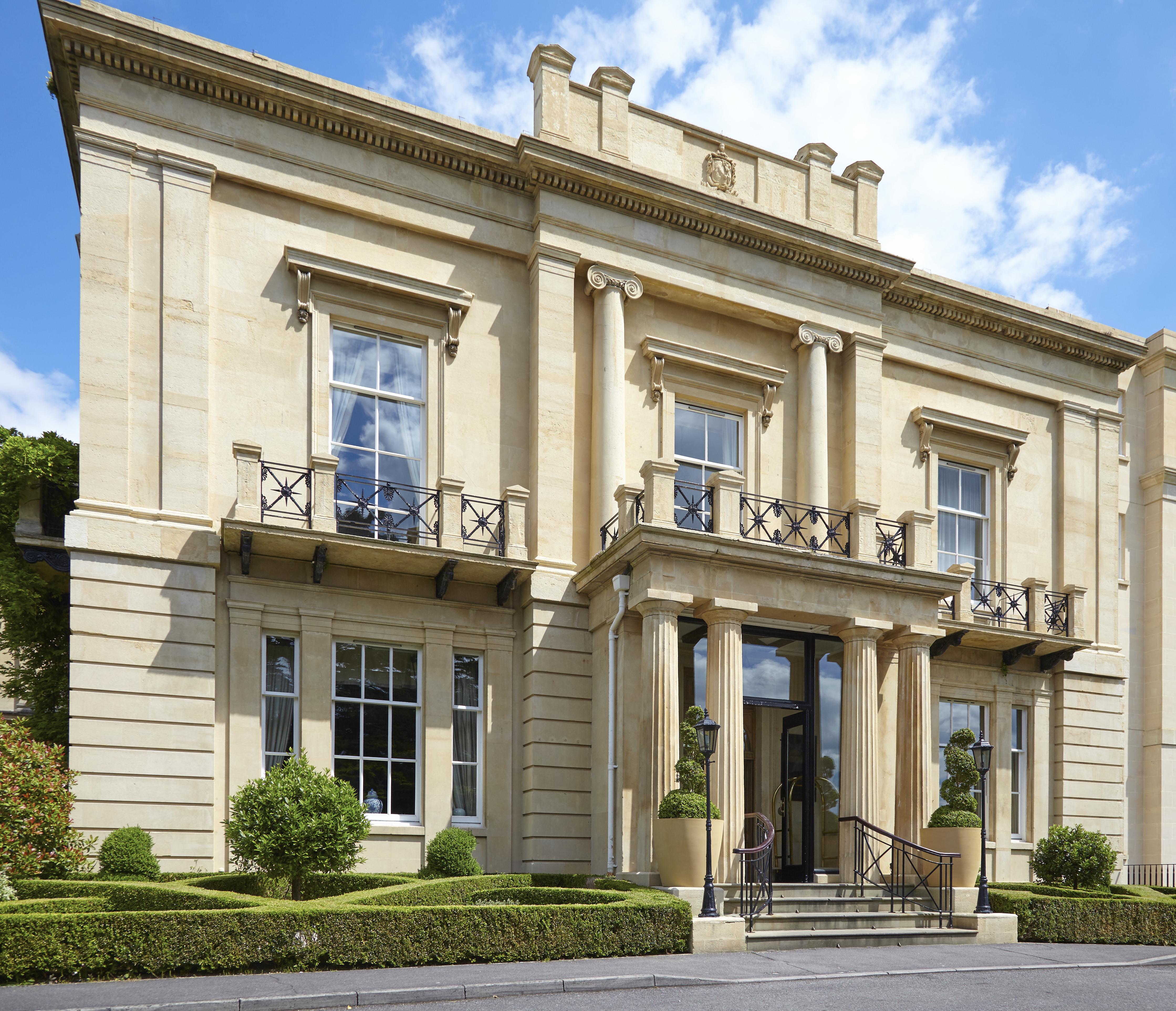 Macdonald Bath Spa Hotel Екстериор снимка The photo shows a large, elegant building designed in a classical architectural style. It features a symmetrical facade with tall columns and decorative details. The entrance is marked by a set of stairs leading up to double doors, flanked by windows